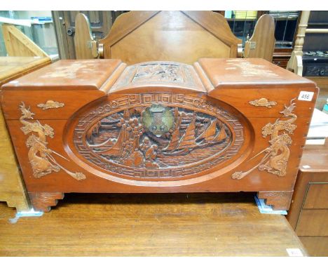 A heavily carved early 20th C camphor wood trunk