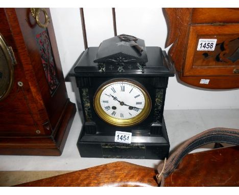 A slate mantel clock with key and pendulum