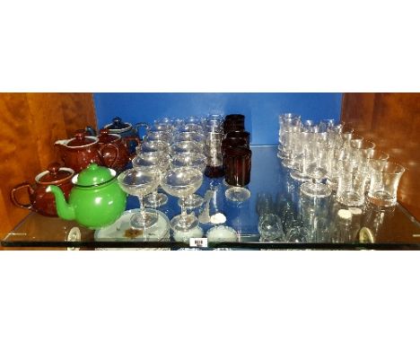 A Large Quantity of Champagne Glasses, Ruby and other Glassware; along with a quantity of Teapots.