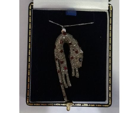 A Gold Diamond and Ruby Cartier Style Pendant.