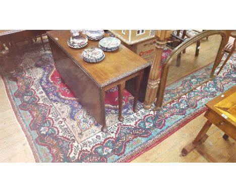 A Multicoloured Medallion Persian Tabriz Carpet on Red Ground.