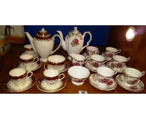 Proceeds to Charity: A Paragon China Coffee Set for Six decorated with pink roses on a gilt embellished white ground complete