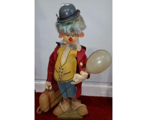 A Vintage Advertising Clown with Suitcase, Umbrella & Bowler Hat.