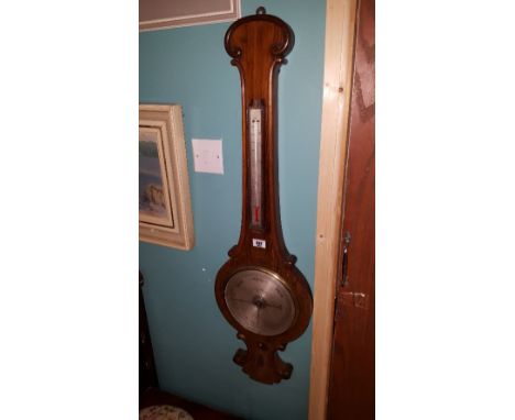 A 19th Century Rosewood Wheel Barometer with an engraved silvered dial and scale.