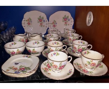 A Sutherland China Tea Set for Eight with eight cups and saucers, seven side plates, two milk jugs, two sugar bowls and two c