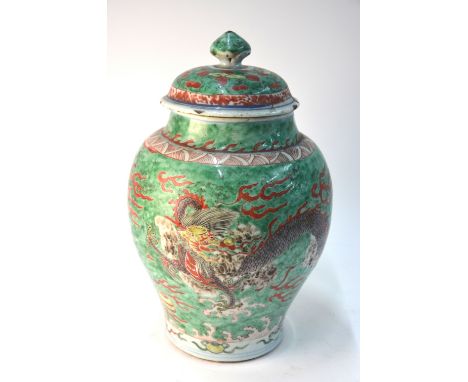 A Chinese wucai oviform vase with unglazed base; the associated domed cover with knop finial; decorated with a four-clawed dr