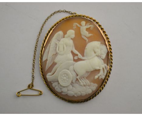 An oval shell cameo of female with lyre board a horse-drawn chariot, yellow metal rope work style setting, approx 6 cm x 5 cm