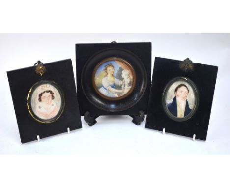 A circular portrait miniature on ivory of a young girl, to/w a pair of oval miniatures of a Regency husband and wife (3)