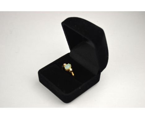 An oval opal and diamond three stone ring, 9ct yellow gold claw setting, size M