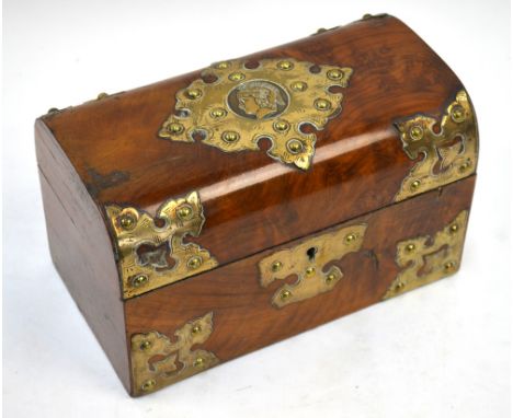 A Victorian brass-mounted walnut tea caddy, mounted with profile of a Greek warrior, the domed lid enclosing two lidded compa