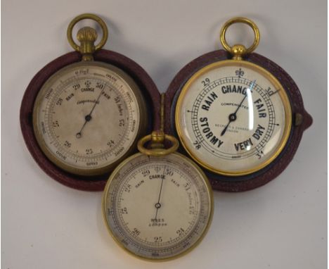 A Negretti & Zambra gilt brass pocket barometer with silvered dial, in fitted leather case, to/w two other uncased pocket bar