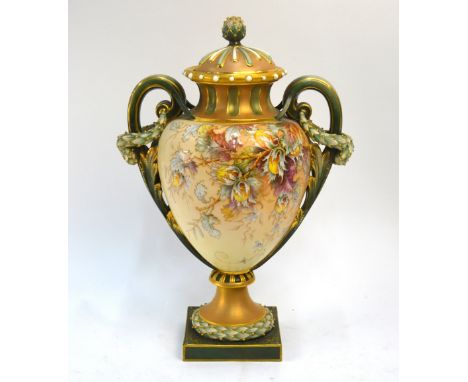 A large Royal Worcester blush ground twin handle vase and cover, painted with branches of nuts or fruit with raised gilding, 