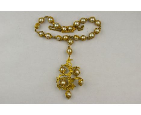 A mid 20th century cultured baroque pearl and gold pendant necklace, with pearls mounted in cast leaf settings, having rectan
