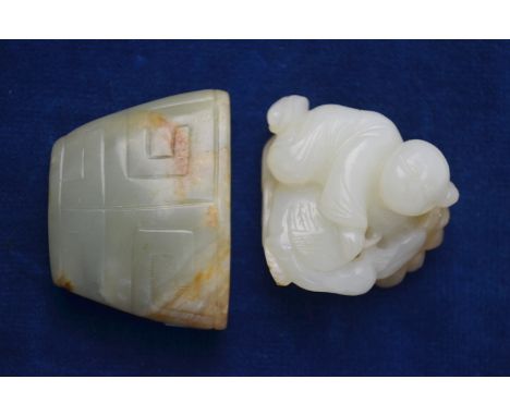 A small green jade of whitish hue with inclusion, carved as a boy beside a tortoise, or other animal, about 4 cm long; togeth