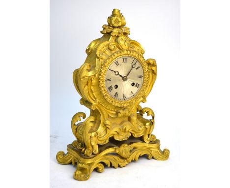 A 19th century French ormolu rococo mantel clock, the movement by Dupont of Paris striking the hours and half hours on a bell