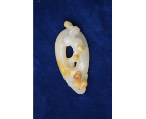 A green jade of whitish hue with some mottled inclusions, designed with a chilong or other mythological animal, about 7.5cm l