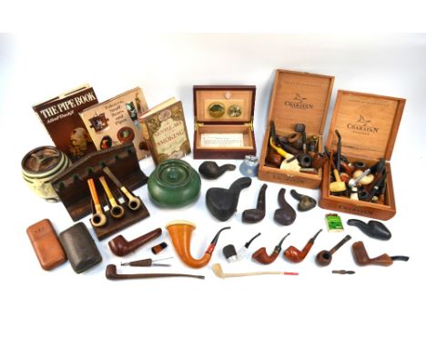 An extensive collection of vintage pipes, ceramic tobacco jars and three books on the subject (box)