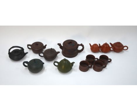 A quantity of Chinese Yi-xing, or other, stoneware, comprising: nine teapots; and four cups; the largest teapot 18 cm wide (1
