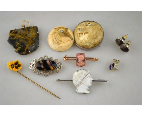 An interesting collection of items including two antique ivory pieces of big cats, specimen stone pendant with gold back, car