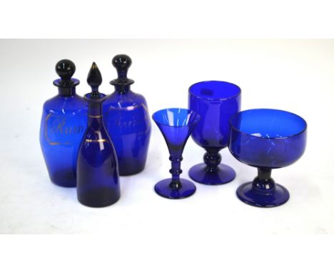 Two early 19th century Bristol blue glass sprit decanters, both gilded and inscribed 'Brandy' and 'Rum', 18.5 cm & 19 cm high