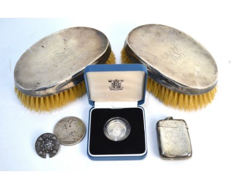 A pair of silver-backed hair brushes, Birmingham 1921, to/w a late Victorian engraved silver vesta case, Birmingham 1899, an 