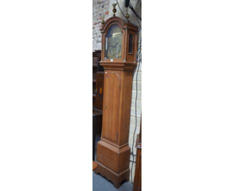 An oak longcase clock of Georgian origin with eight-day movement striking on a bell, arched brass dial with ornately cast and