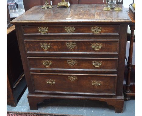 An 18th century oak chest of four long graduated drawers having applied moulded edges and raised on shaped bracket feet, 90 c