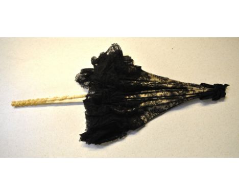 A black Chantilly lace parasol with foliate and carved ivory shaft and ferrule, three finely beaded evening bags, three Victo