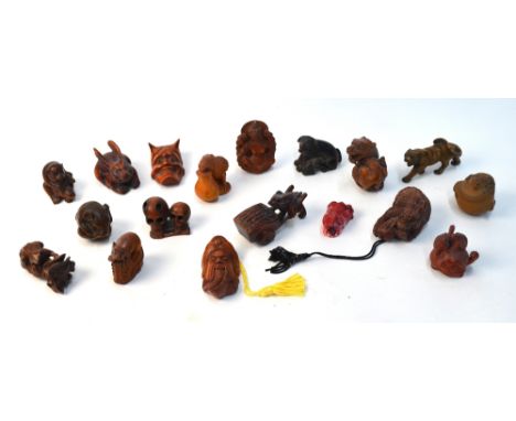 A Japanese netsuke of a striding tiger; together with seventeen netsuke, or other, small carvings (18)