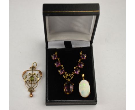 An oval opal pendant yellow metal claw setting to/w peridot and seed pearl Art Nouveau pendant yellow gold set and mauve past