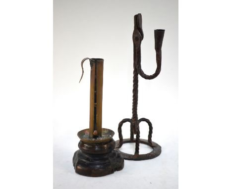 A wrought iron rush-light, 34 cm, to/w a tubular brass candle-lamp with sliding extender, on turned wood base, 25 cm