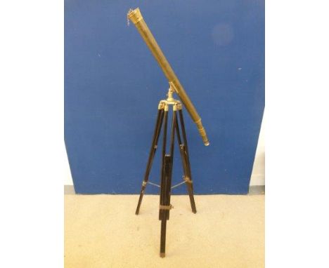 A contemporary brass telescope mounted on a tripod base. 