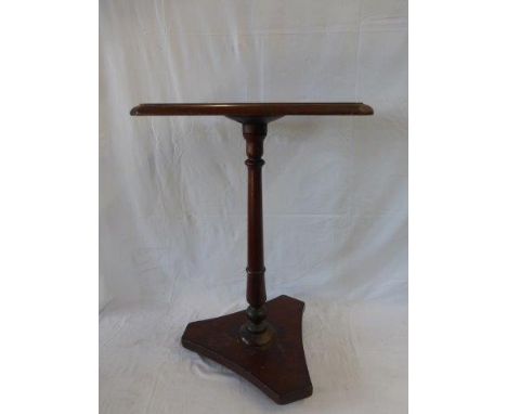 A Victorian mahogany occasional table raised on a turned, tapering column.