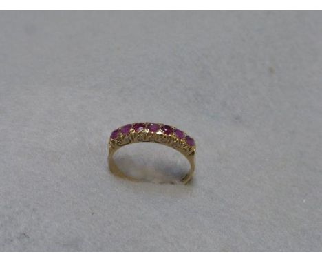 A Victorian style 9ct gold seven stone ruby ring, size Q.