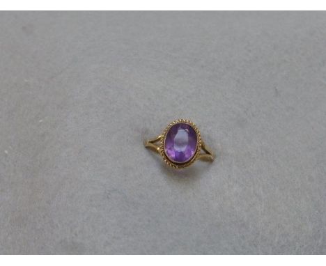 A 9ct gold ring set with a multi-faceted amethyst, probably Edwardian.