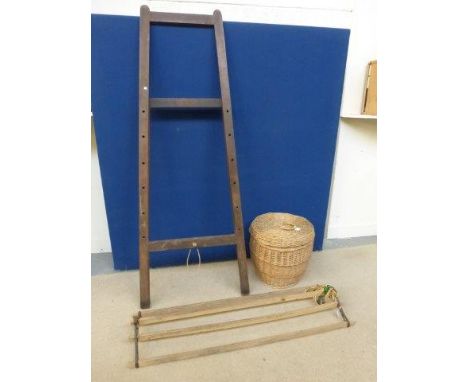 A folding easel, a lidded wicker basket and a kitchen ceiling clothes airer maid with pulley system. 