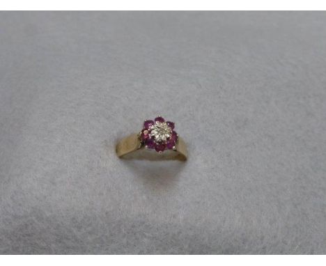 A 9ct gold diamond and ruby cluster ring, size L/M.