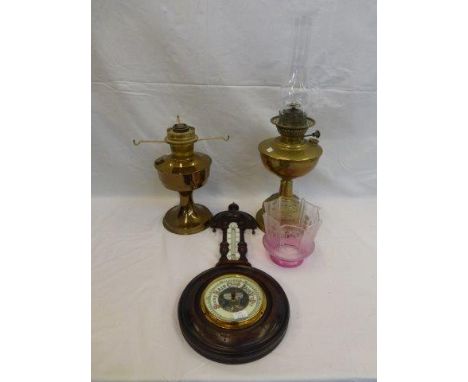 Two brass oil lamps with etched cranberry tinted shade and an oak framed wall barometer. 