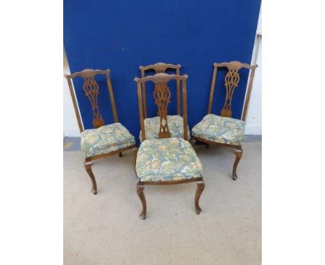 A set of four Edwardian Chippendale style dining chairs.