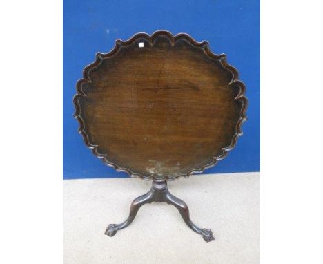 A 19th Century mahogany piecrust circular tilt top table, the part carved column to cabriole swept supports, with well define