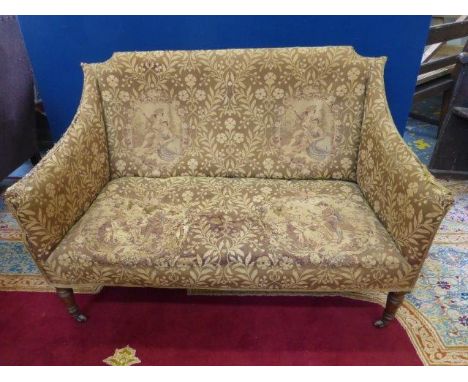 An Edwardian two seater settee of small proportions with tapestry cover, raised on turned front supports to castors. 