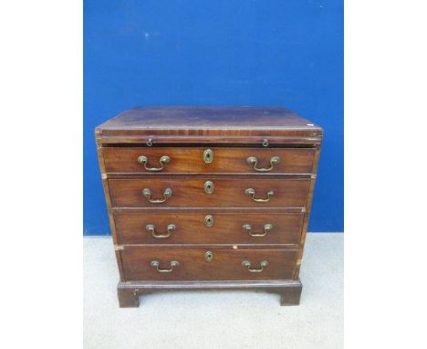 A George III mahogany caddy top chest of four long drawers, with brushing slide, raised upon bracket feet; the handles appear
