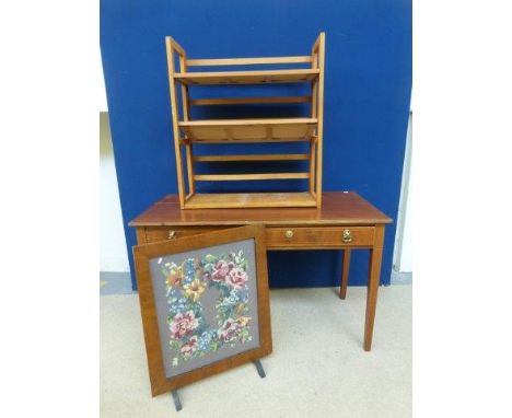 An inlaid mahogany two drawer desk raised on square tapering supports; a firescreen and a set of folding shelves. 