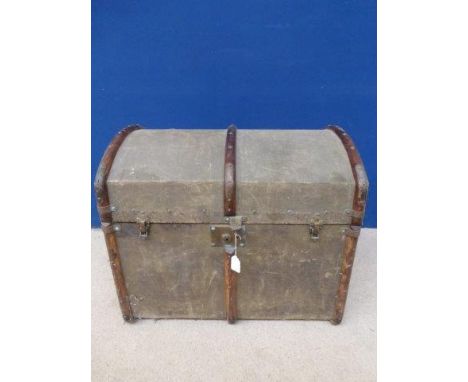 A 19th Century canvas and wooden bound dome topped travel trunk with interior label T.B & W Cockayne .L. Sheffield.