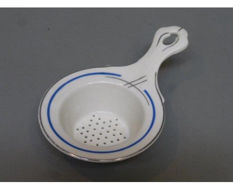 A rare Art Deco porcelain tea strainer pierced in a star shape, ideal also for icing sugar. 