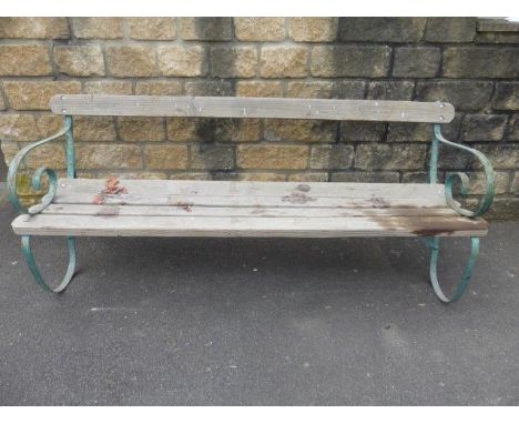 A Victorian wrought iron garden bench with replacement timbers. 