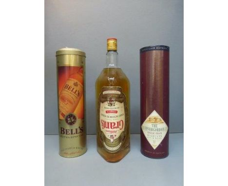 A cased bottle of The Invergordon Single Grain Highland Scotch Whisky, a cased bottle of Bell's Scotch Whisky and a large bot