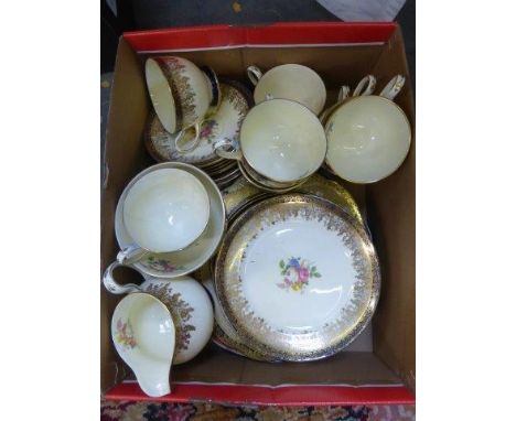 A gilt and floral decorated Collingwoods, England eight setting tea set and two Spode ironstone Imari patterned plates.