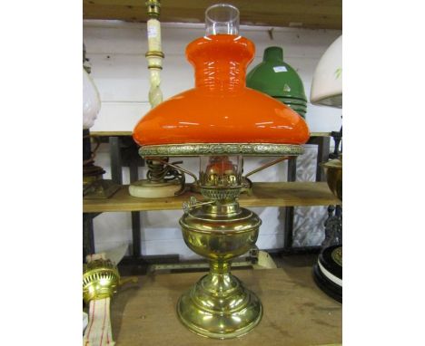 Brass oil lamp with funnel and orange glass shade
