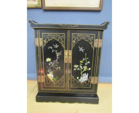 A lacquered jewellery cabinet with mother of pearl and gilt and hand painted detail 47cmH 39cmD 35cmW slight damage to one co